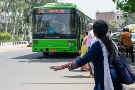 A woman waiting for an E-bus