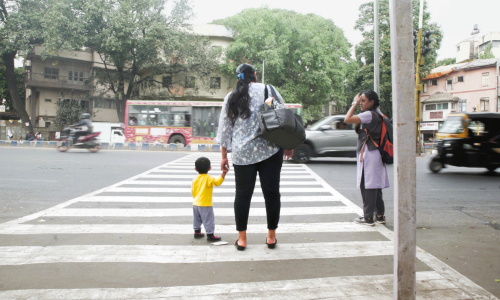 A mother and a toddler cross a road in Pune. Photo by Ameya Mahale/WRI India. 
